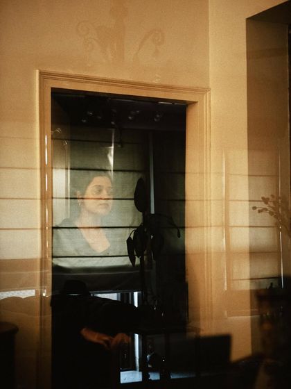 An artistic shot from my 'Doorways in Colour' series, capturing a friend through a reflection. These are the quiet, everyday moments that hold so much meaning.