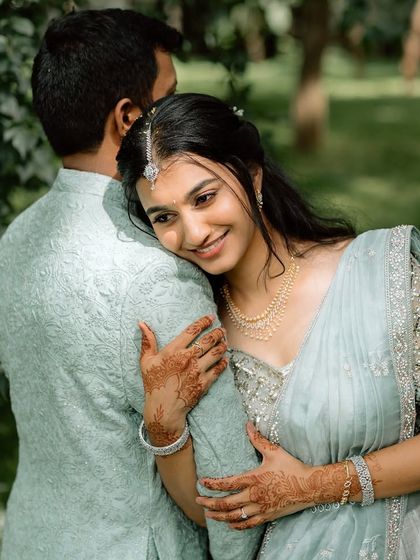 A sweet, intimate moment from an engagement shoot. The bride's makeup is natural and enhances her features, perfect for these close-up, emotional shots.