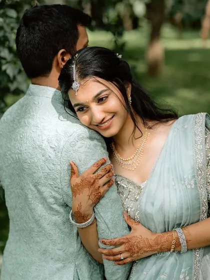A sweet, intimate moment from an engagement shoot. The bride's makeup is natural and enhances her features, perfect for these close-up, emotional shots.