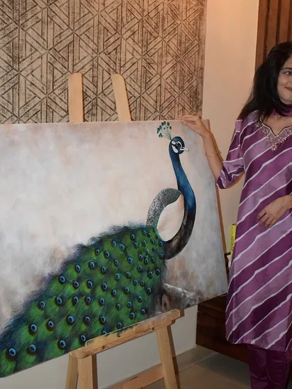 A candid shot of me with my finished peacock painting. It captures the proud, happy moment of completing a large and challenging piece of art.