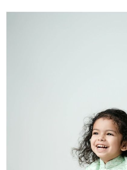 Smiles are the language of love. This minimalist portrait with lots of negative space beautifully frames a child's infectious, happy laugh.