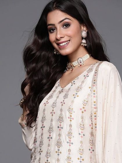 A cream kurta pant set with jacquard woven work. The subtle texture and elegant design make it a sophisticated choice for any occasion.