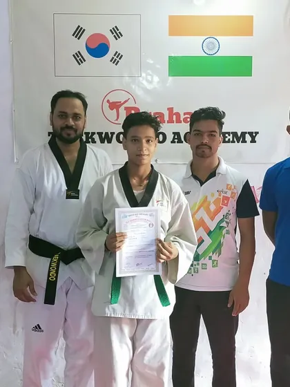 A senior student receives his certificate, marking his progress towards the next level.