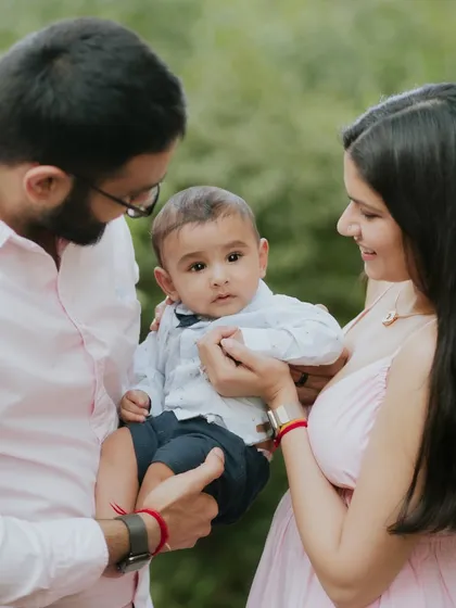 A family of three, holding their world in their hands. This is a classic and timeless family pose.