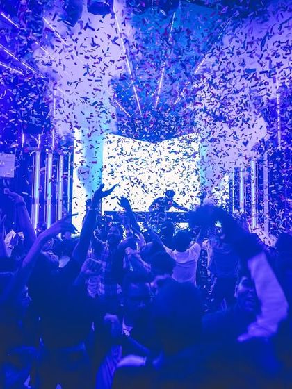 A blue-lit confetti drop at the Flo Finale. The lighting and effects are timed perfectly with the music to create peak moments throughout the night.