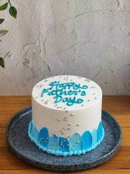 A simple and elegant "Happy Father's Day" cake with a beautiful blue watercolor design, perfect for celebrating your hero.