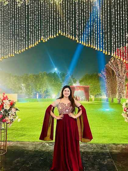 Posing at the venue of an amazing 25th wedding anniversary. The outdoor setting with beautiful lighting was perfect for the grand celebration.