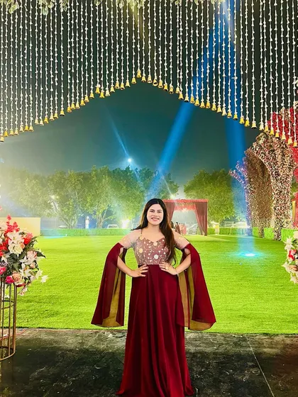 Posing at the venue of an amazing 25th wedding anniversary. The outdoor setting with beautiful lighting was perfect for the grand celebration.
