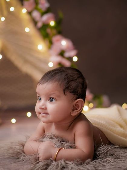 A world of wonder in their eyes. This milestone session captures a baby's curiosity as they explore their surroundings.