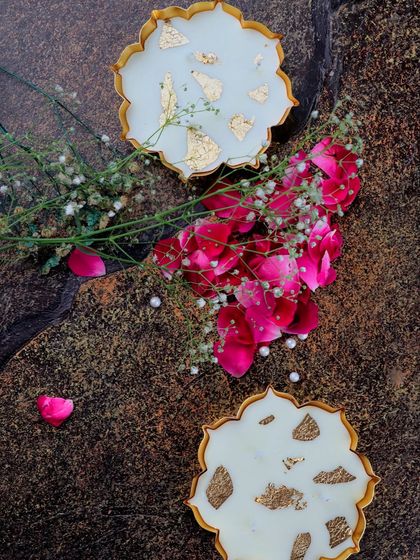 Two of my mini gold metal urli candles, styled with scattered rose petals and baby's breath. This shows how beautifully they can be incorporated into your festive decor.