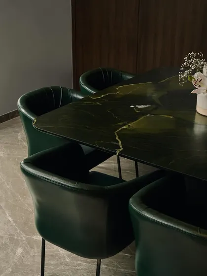 I believe in using materials that make a statement. This dining table is crafted from a rare Brazilian Avocatus Green Quartzite with a leathered finish, creating an earthy yet luxurious centerpiece. The stone's natural durability ensures it is as practical as it is beautiful.