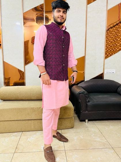 A full-length shot of the pink and purple kurta jacket set, a perfect outfit for a daytime wedding function or festive celebration.