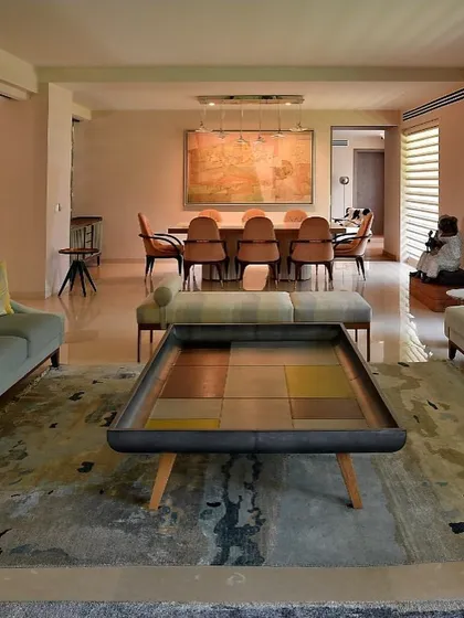 In this Delhi renovation, I removed interior walls to create a flowing, open-plan living and dining area. A consciously chosen pastel palette of soft blues, lavenders, and beiges enhances the lightness and creates an oasis of calm in the city.