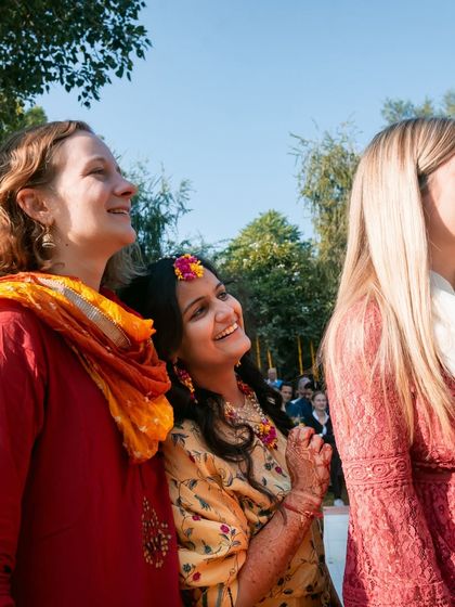The bride enjoying her haldi ceremony with her international friends, a beautiful blend of cultures.