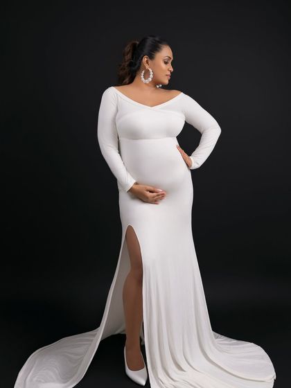 A strong, fashion-forward pose that shows off the gown, the bump, and the client's confidence.