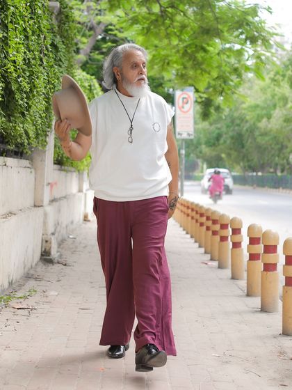 A walking shot that creates a sense of movement and narrative, as if capturing a moment from the model's daily life.