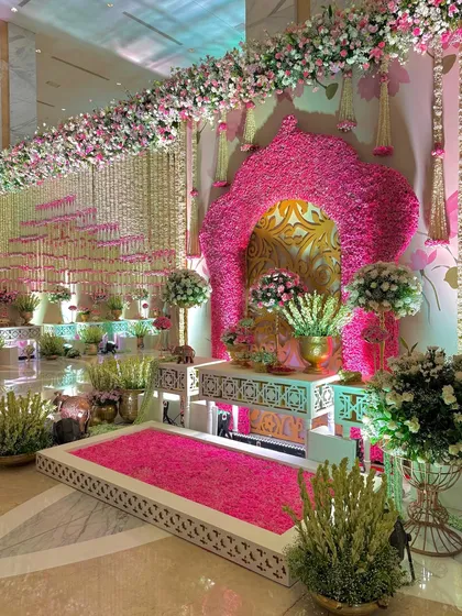 A wider angle of the photo corner, showing how it integrates into the larger space with floral garlands and a cascading wall of flowers.