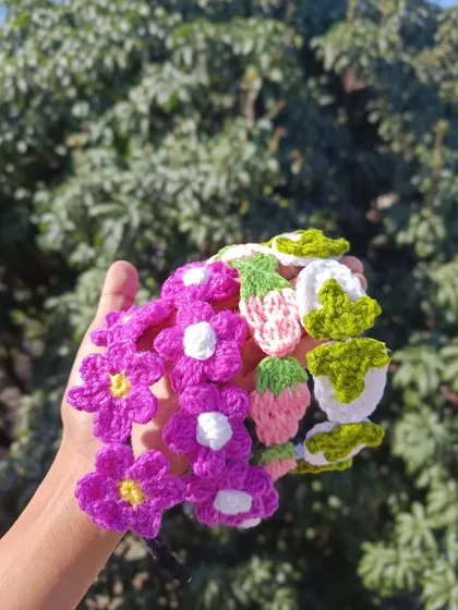 A handful of custom crochet hairbands. This order featured purple flowers and pink strawberries, perfect for a cute and coordinated look.