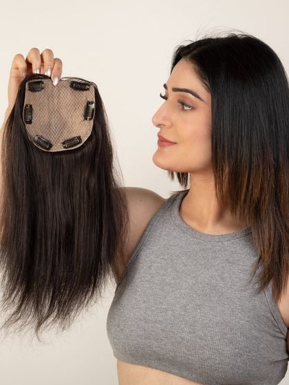 A model showing the clip details of a smaller hair topper.