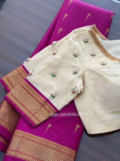 A full view of the off-white blouse, perfect for a classic look.