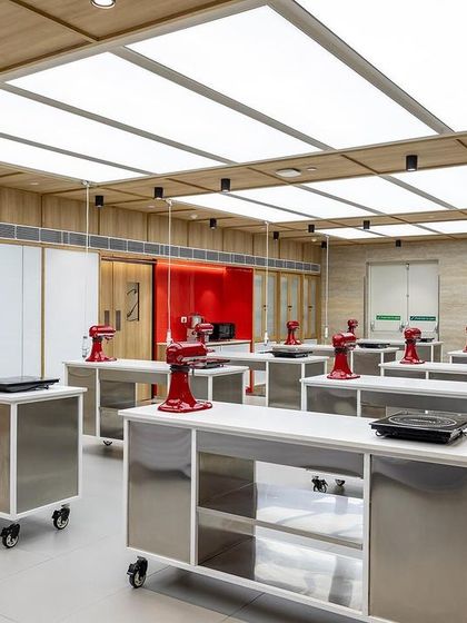 The classroom is set and ready for a professional course, with pristine workstations and top-of-the-line equipment.