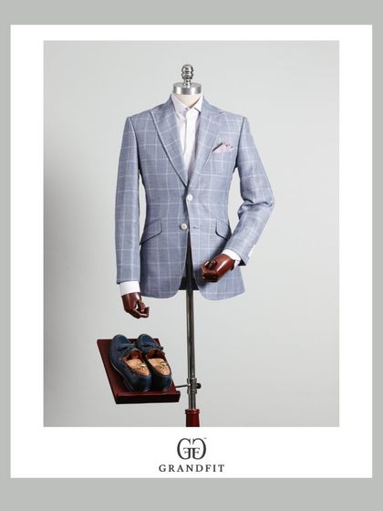A featherweight suit in a light blue windowpane check. This is an excellent option for business in warmer climates, offering style without sacrificing comfort.