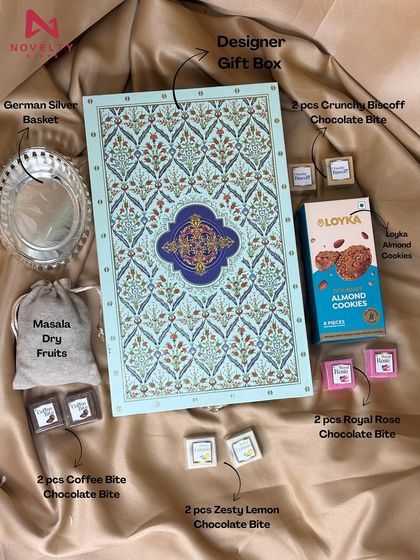 A truly royal hamper. This set includes a designer gift box, a German silver basket, masala dry fruits in a pouch, assorted chocolate bites, and almond cookies. It’s a luxurious gift meant to impress.