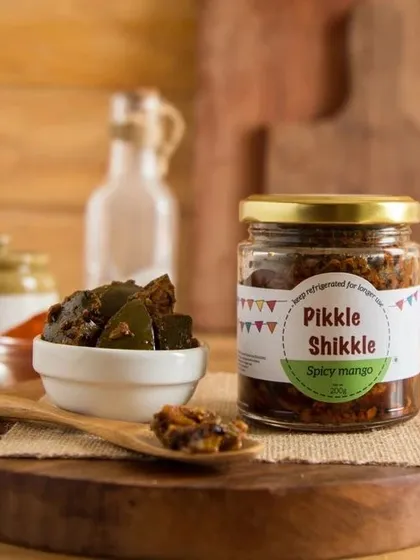 A jar of my Spicy Mango pickle, ready to add a kick to your meals. This is the taste that many of my customers grew up with.