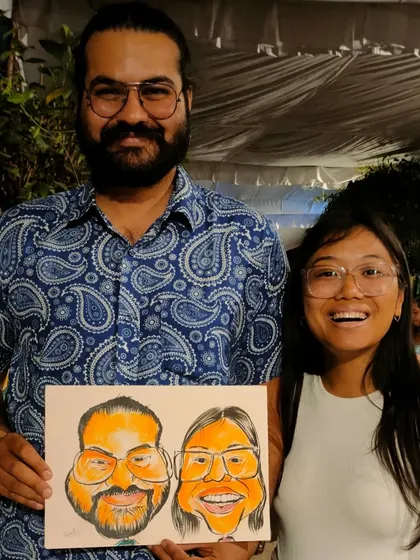 A happy couple with the quick caricature I drew for them at a live event. Their smiles show how much fun it is to get a personalized piece of art on the spot.