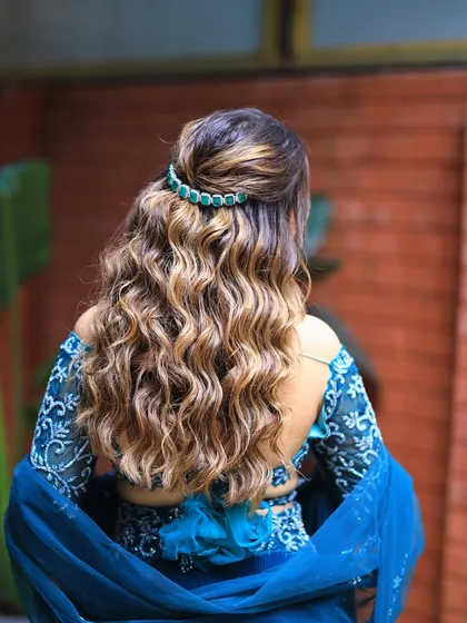 A back view of beautiful, defined curls. This half updo is a great way to show off hair color and texture.