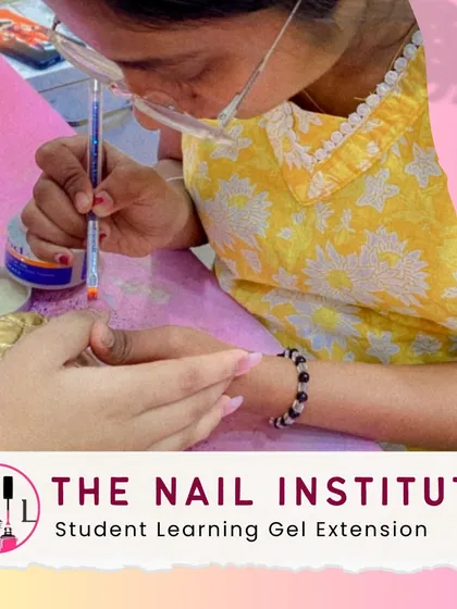 A student carefully applies gel to create a nail extension, learning how to build a strong and beautiful apex.