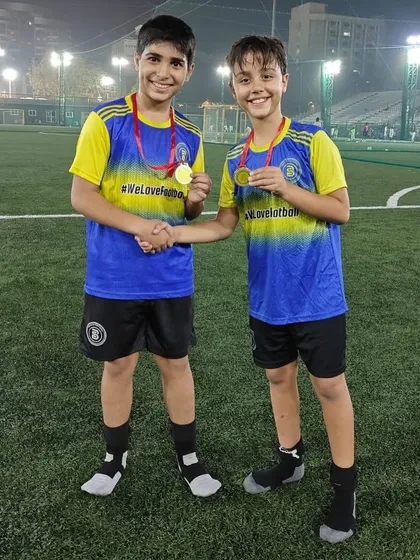 Two teammates celebrating their Player of the Month awards together. That is what teamwork is about.