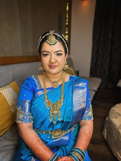 For this beautiful Iyengar bride, I focused on a subtle and classic look. The makeup enhances her features with soft tones and a flawless finish, allowing the magnificent blue Kanjivaram saree and traditional jewellery to take center stage.