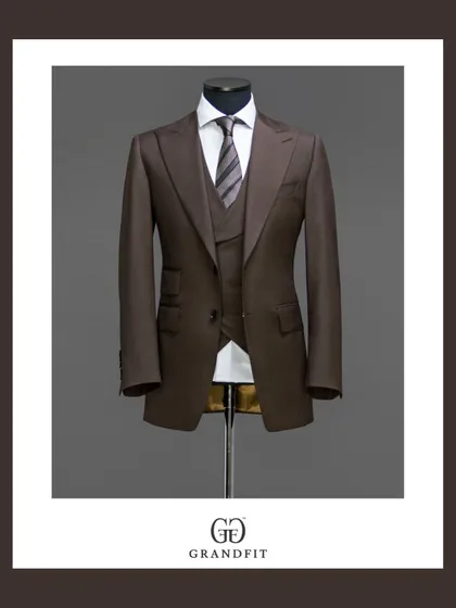 This bespoke three-piece suit in a rich brown fabric demonstrates true versatility. The addition of a matching waistcoat provides a layer of sophistication, making it an impeccable choice for business or formal occasions.