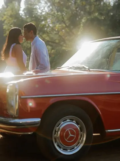 I have a soft spot for that 90s cinematic aesthetic, and this shot gives me all the feels. We found this vintage red Mercedes for a shoot in Goa, and the golden hour light just poured in. It’s moments like this, a quiet kiss against the setting sun, that feel like a scene straight out of a movie.