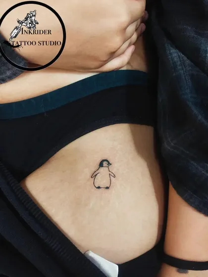 A cute and simple penguin outline. This minimalist hip tattoo is a perfect choice for animal lovers looking for a subtle and charming design.