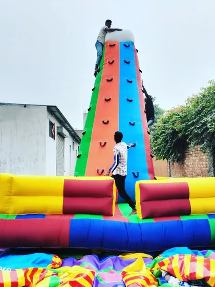 People actively using our 16x16 feet, four-sided inflatable climbing tower. This design allows multiple climbers at once, making it efficient for handling crowds at events.
