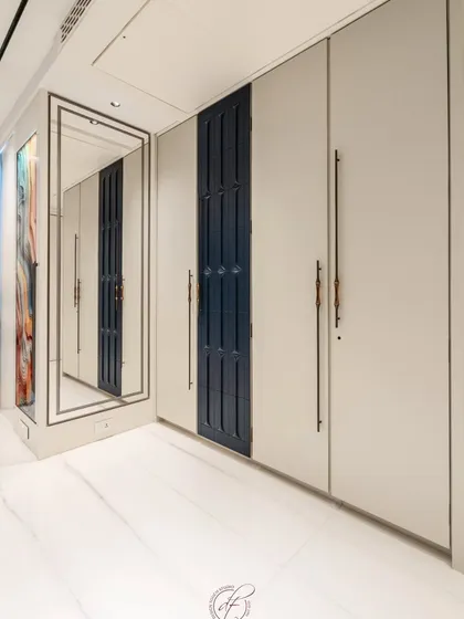 The beauty is in the details. This wardrobe features a striking textured blue panel and sleek, custom-designed long handles that add a touch of modern artistry.