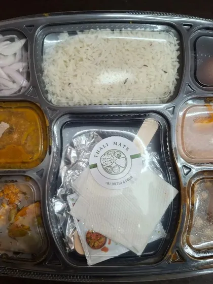 A neatly packed lunch thali with my brand sticker, ensuring hygiene and professional presentation for every order.