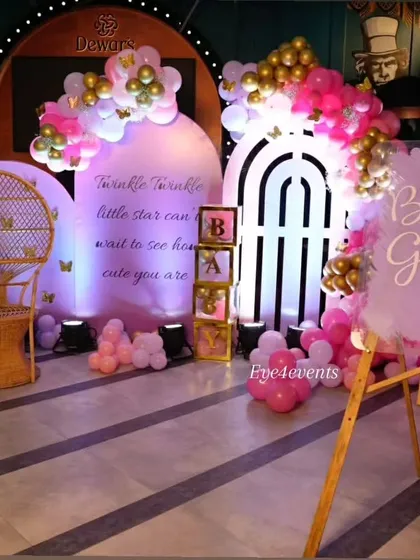 A dreamy "Twinkle Twinkle Little Star" baby shower. We used a soft lavender and pink color palette with backlit backdrops, a wicker peacock chair, and a custom sign to create a magical and ethereal atmosphere for the mom-to-be.