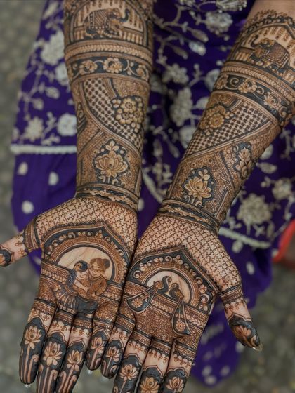 A detailed shot of the palm, where the portrait of the bride's aaji is the centerpiece, surrounded by delicate floral and geometric patterns.