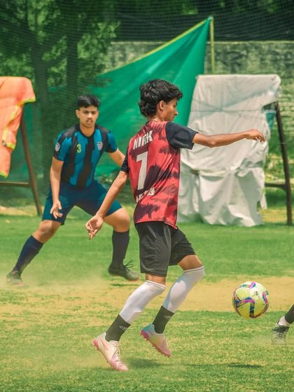 A player dribbles forward, looking to take on a defender.