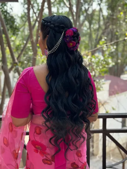 A side view that highlights the texture of the waves and the intricate floral and chain accessory.