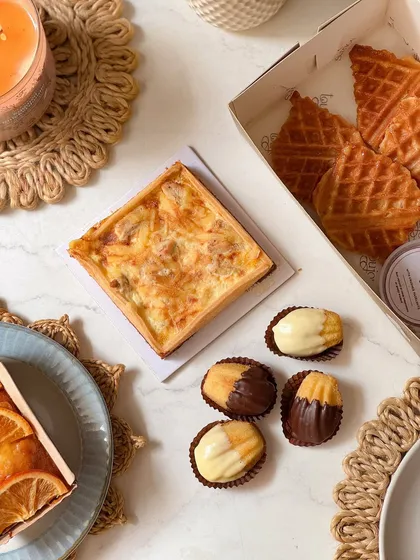 A Father's Day brunch box with a mix of sweet and savory treats, including a quiche, mini croffles, and chocolate-dipped madeleines. It's an ode to those special Sunday breakfasts with Dad.