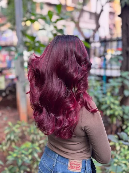 Got red hair and wings. This vibrant, fiery red is for the bold and fearless, styled in beautiful waves to show off its intensity.