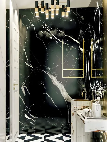 A luxury powder room with black marble walls and gold accents. The design is bold and sophisticated, with a modern chandelier and geometric floor tiles.