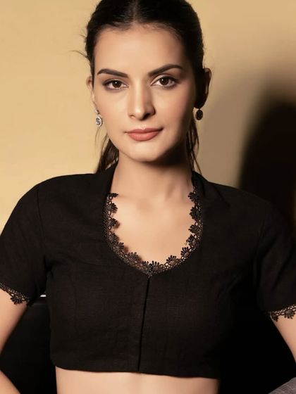 Color block ka classy twist! This black blouse with delicate lace detailing along the V-neck and sleeves is perfect for a festive or party look. It’s a limited edition piece.