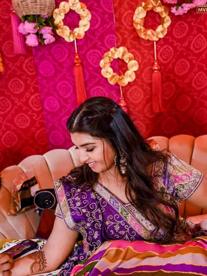 A candid shot of the bride, her smile as bright as the colorful decor surrounding her.