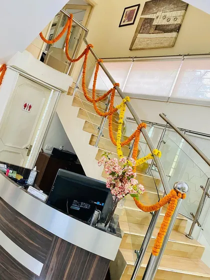 This is how I bring a festive feel to office interiors. By wrapping the staircase railing in an office reception area with simple marigold garlands, the entire common space feels brighter and more welcoming for staff and visitors.