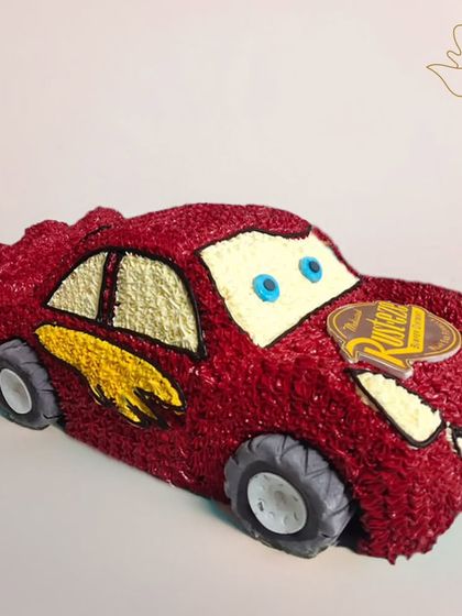 Vroom! A fantastic 3D Lightning McQueen cake, complete with his signature red color and racing decals. This cake is sure to be a winner with any "Cars" movie fan.